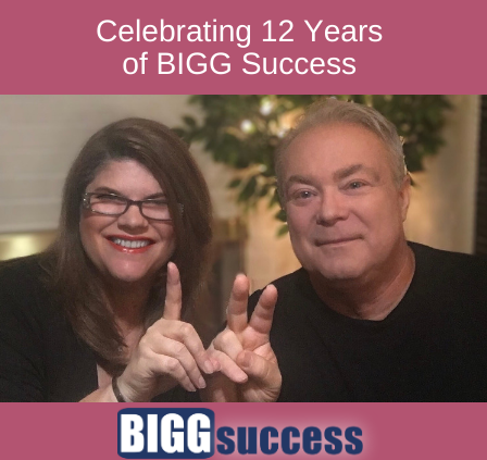 George and Mary-Lynn are fingerspelling the numbers 1 and 2 with the blog post title: Celebrating 12 Years of BIGG Success